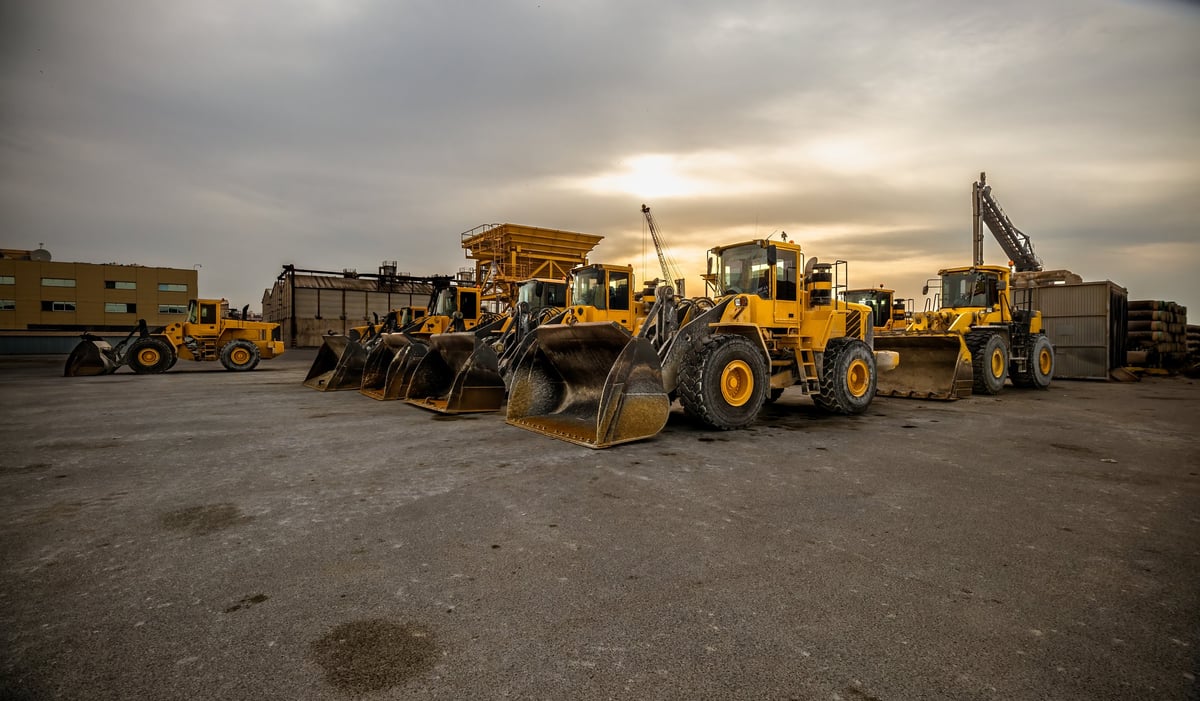 Yellow wheel loader and bulldozer on construction site