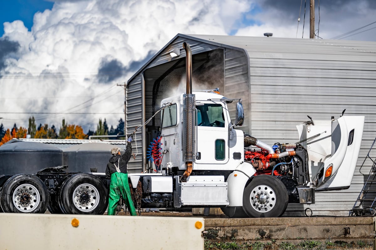 Professional mobile pressure washing semi truck at industrial wash station