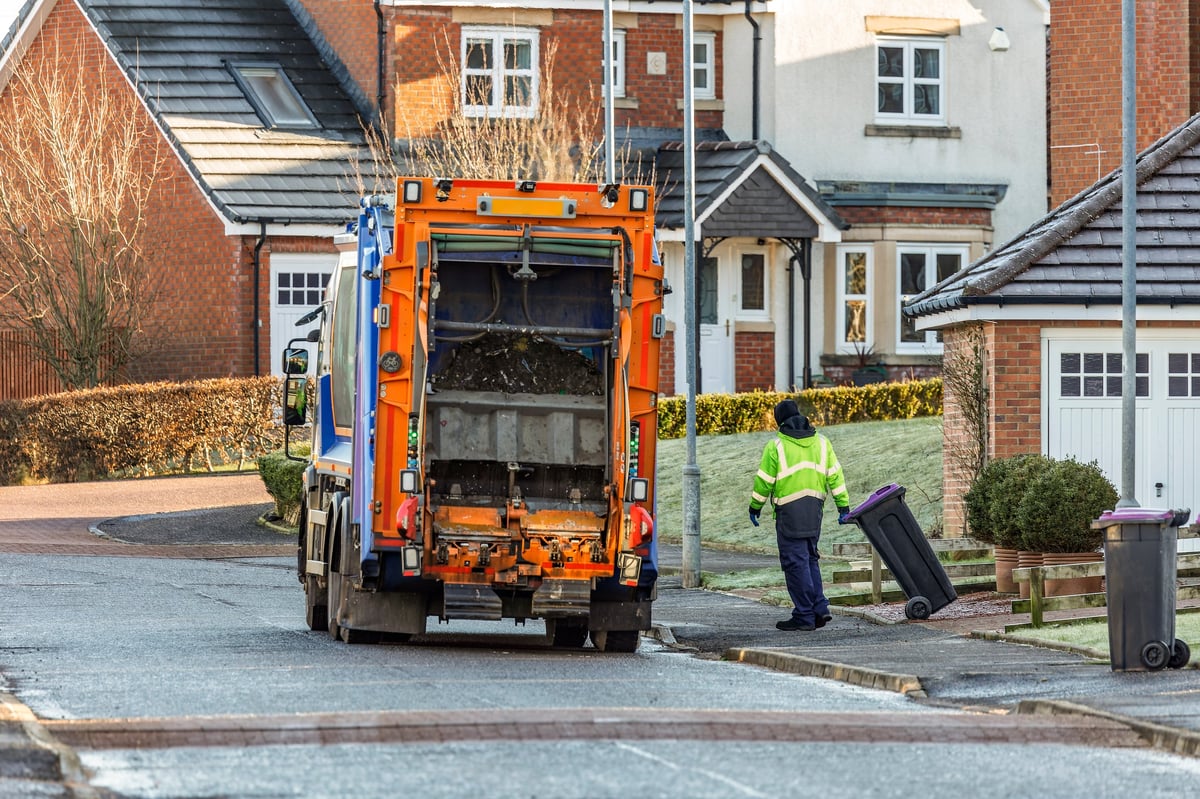 Municipal refuse truck collecting residential waste recycling