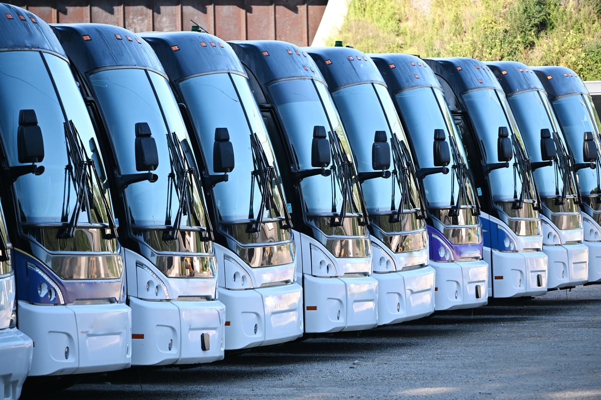 Commercial vans parked in a row at a fleet yard