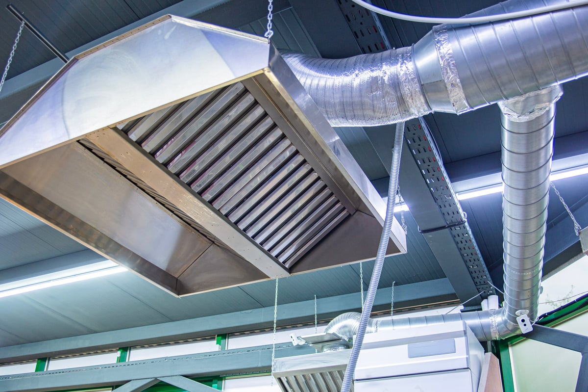 Industrial kitchen exhaust hood with grease trap