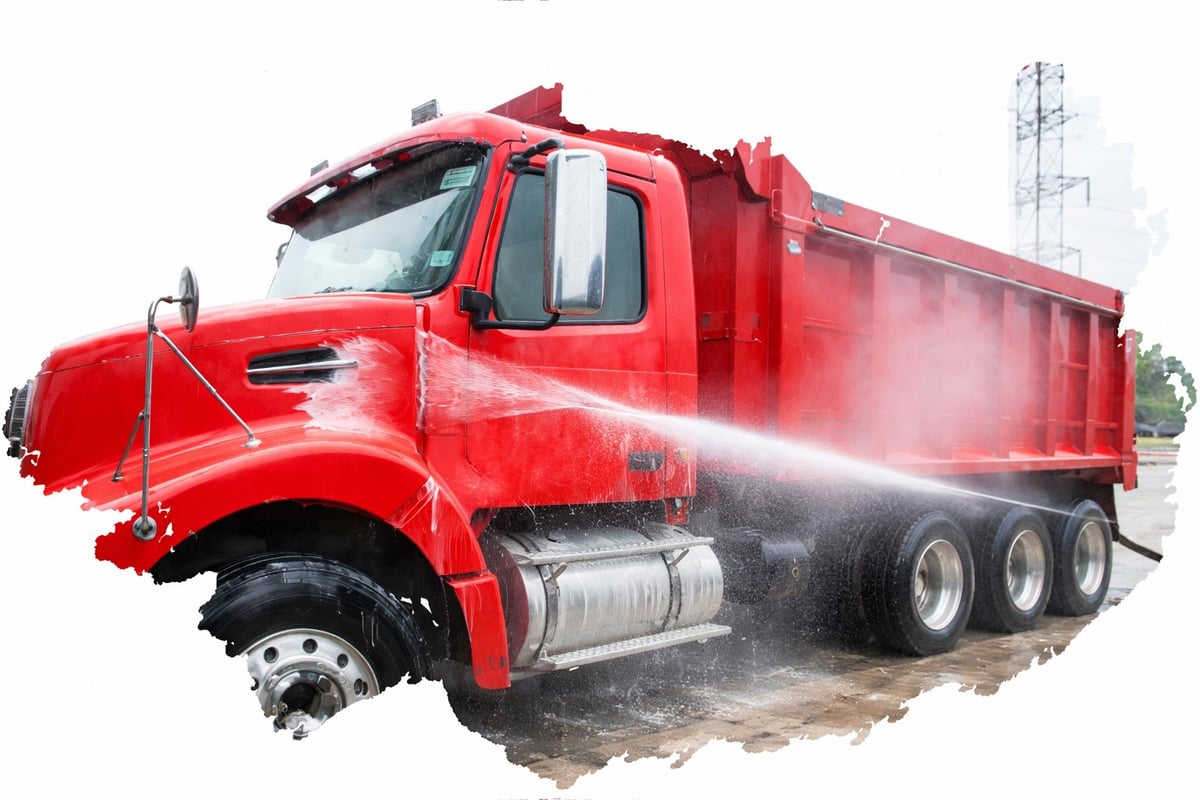 Red dump truck spraying water with large capacity cargo bed and dual rear wheels